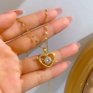 Macro shot of gold-plated heart necklace with cubic zirconia pendant worn on neck
