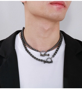 Close-up of industrial style vintage titanium steel necklace with OT barbell clasp on model