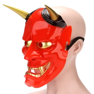 Side view of Japanese Hannya mask with gold horns and teeth on a white background