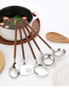Five-piece stainless steel kitchen tool set with dark walnut wooden handles on white surface