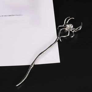 Detailed macro view of silver metal hair stick with a 3D gothic spider head design