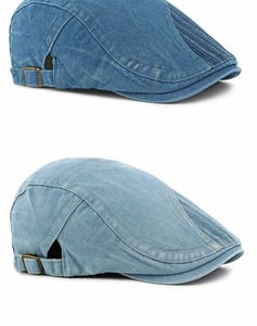 Détail d'un béret en denim délavé avec boucle réglable en bronze et surpiqûres