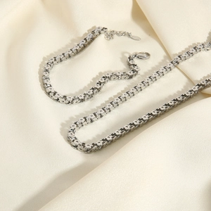 Polished stainless steel necklace and bracelet set with unique floral link design