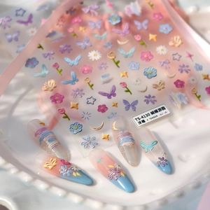 5D embossed floral nail art stickers with butterfly and flower designs on blue nails