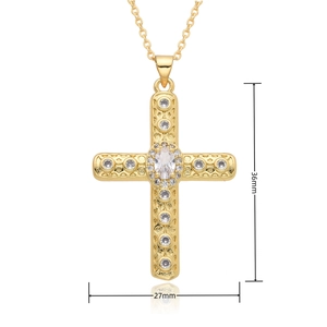 Detail view of a gold cross pendant with cubic zirconia and size dimensions of 36mm by 27mm