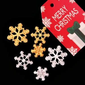 Detail of assorted gold and silver resin snowflake charms for Christmas DIY decorations