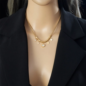 Elegant gold titanium steel necklace with diamond-encrusted round pendant on snake chain