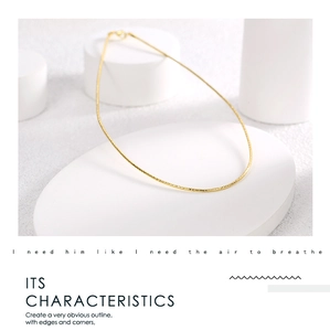 Minimalist gold thin chain necklace displayed on white geometric stand with elegant typography