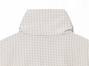 Detail of stand collar and shoulder area on black and white checkered nylon jacket
