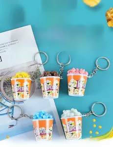Detailed view of colorful popcorn model keychains in yellow, blue, and pink