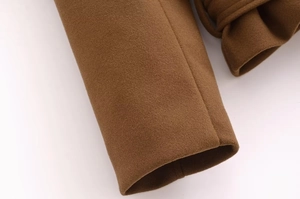 Close-up of brown wool coat cuffs showcasing fabric texture and sewing craftsmanship