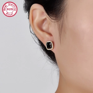 Close-up of S925 silver rectangle black gemstone earring with halo diamond border on ear