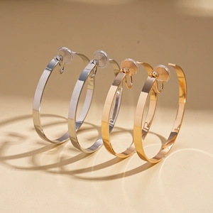 Minimalist geometric gold and silver metallic hoop clip-on earrings with comfort silicone pads