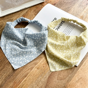 Blue and yellow floral chiffon headscarves with elastic bands on a wooden background
