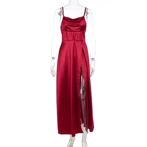 Detail of high-slit hem and waist stitching on a dark red satin evening gown