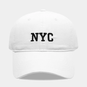 Close-up of black NYC letter embroidery on a white vintage washed cotton baseball cap