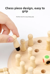 Macro shot of a child's hand holding a colorful wooden memory chess piece on a board