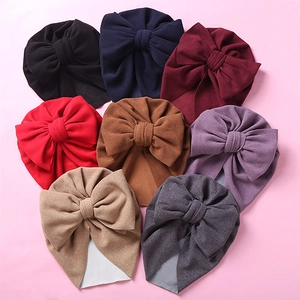 Soft multi-color baby turban hats featuring large double bows for winter warmth and comfort
