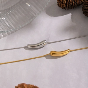 Minimalist geometric curved pendant necklaces in gold and silver with snake chains