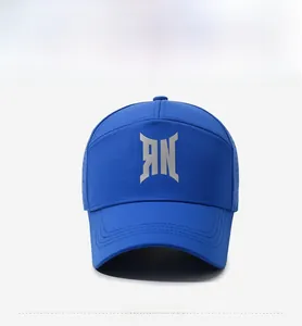 Detail of navy blue baseball cap with silver geometric logo and breathable mesh fabric