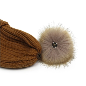 Brown knitted beanie with detachable faux fur pom poms and snap-on button detail