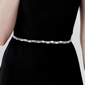 Detailed macro view of silver rhinestone bridal waist chain with double-row sparkling crystals