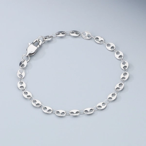 Macro shot of silver coffee bean link bracelet with secure lobster clasp closure