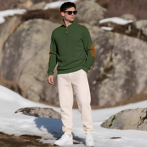 Men's green half-zip knit sweater with brown elbow patches in outdoor snow setting
