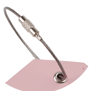 Close-up of pink PU leather luggage tag with secure metal wire ring on white background