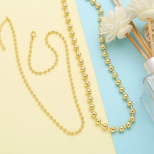 Detailed comparison of gold bead necklaces in three distinct ball chain thicknesses