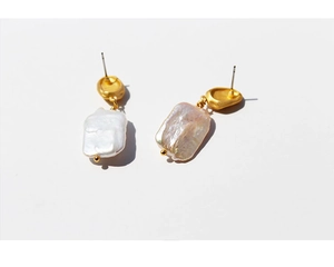 Detail view of vintage baroque square pearl earrings with matte gold plated metal finish