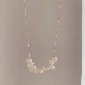 Detail of natural freshwater Baroque pearls on a slim gold chain necklace for women