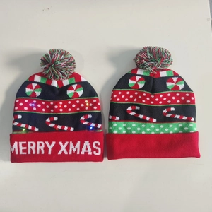 Detail showing knitted Christmas hat with LED lights and Merry Xmas text patterns
