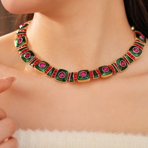 Detail of vintage square enamel necklace with pink stones on a golden metal chain