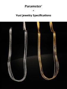 Close-up of layered silver and gold silk-textured titanium steel strand necklaces