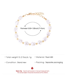 Detail of irregular pearl bracelet with starfish seashell charms and lobster clasp