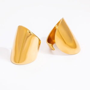 Macro shot of two wide 18k gold-plated stainless steel rings with glossy metallic finish