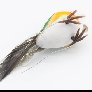 Detail of artificial robin bird with white foam body, yellow back, and grey real feathers