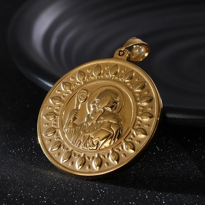Detailed close-up of golden Saint Benedict medal with intricate embossed relief and patterns