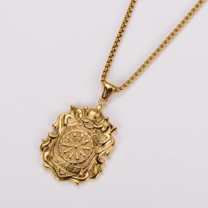 Detailed close-up of golden stainless steel shield pendant with crown and darts engraving