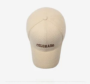 Top view showing textured beige fabric and brown COLORADO embroidery on baseball cap