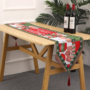 Close-up of a festive knitted Christmas table runner with tassels and Feliz Navidad print