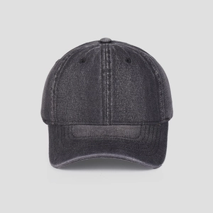 Detailed texture of washed charcoal grey denim fabric on a minimalist baseball cap
