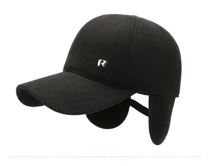Detail view of winter baseball cap with ear flaps and silver metallic sport logo