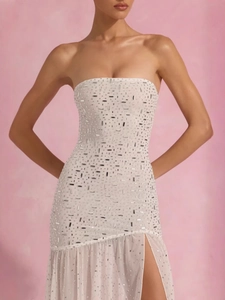 Elegant white sequin tube dress with side slit and ruffle hem for party wear
