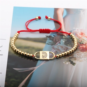 Adjustable red rope bracelet with gold beads and a zircon pavé lock charm for women