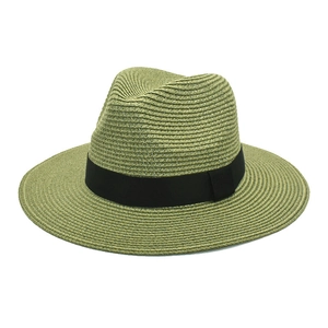 Detail of army green straw Panama hat with black grosgrain ribbon on white background