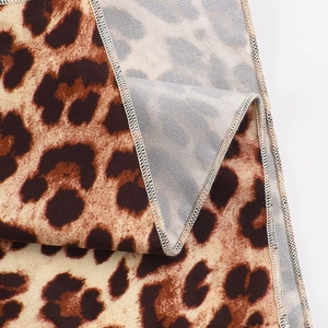 Macro view of leopard print fabric texture and overlock edge stitching on summer dress