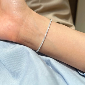 Close-up of a delicate 925 silver tennis bracelet with sparkling zircon stones on wrist