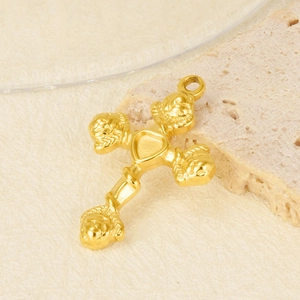 Macro detail of golden 304 stainless steel cross pendant with heart and embossed face